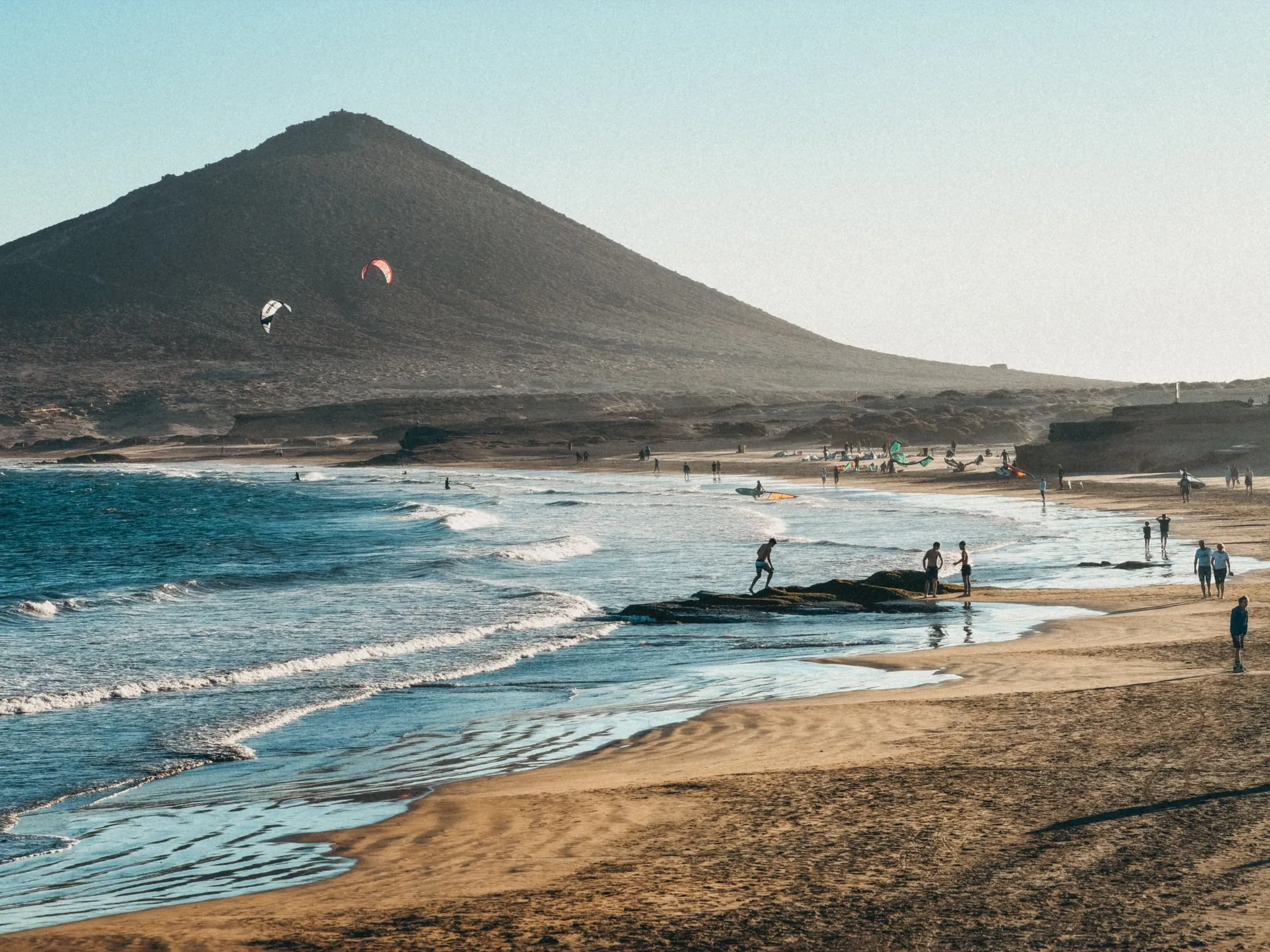 Kitesurfers off El Médano below the red cone of Montaña Roja